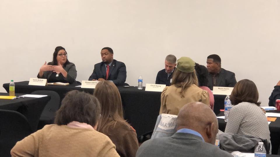 Yamile "Yaya" McBride speaking as a panelist at an education leadership panel.
