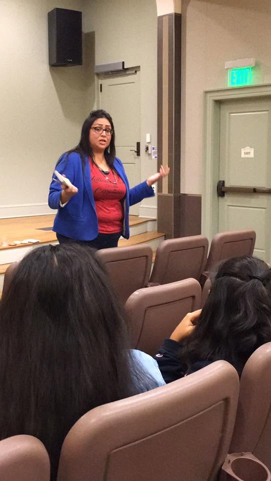 Yaya speaking to a room of students.
