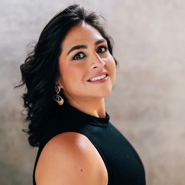 Portrait of Yamile "Yaya" McBride, smiling, in a black sleeveless top.